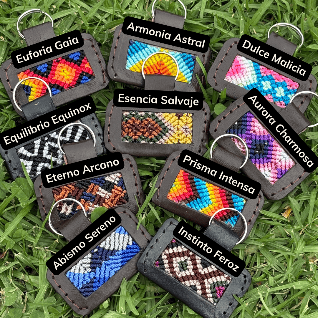 Handcrafted custom dog ID tags showing all patterns with name labels, leather trim and key rings, flat lay on grass